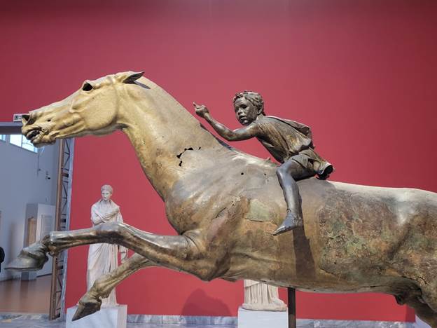 A statue of a person riding a horse
Description automatically generated